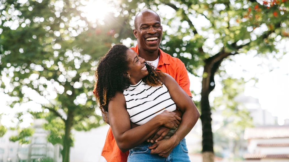 Smiling couple embracing outdoors