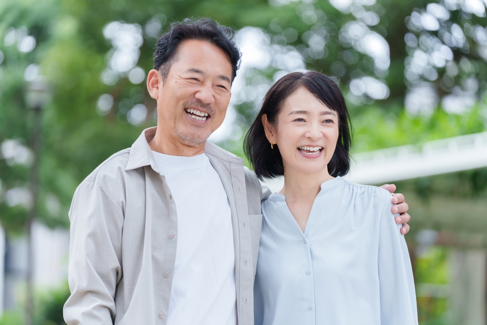Smiling couple standing together outdoors