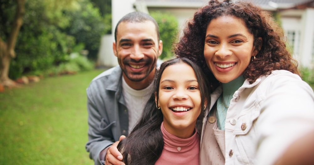 Smiling family taking a selfie outdoors