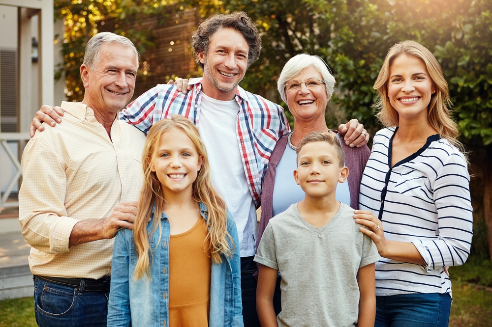 Three generations of a smiling family outdoors