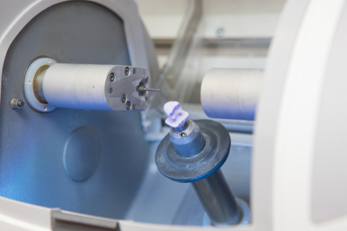 Milling machine shaping a same-day ceramic crown